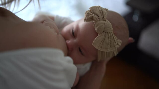 Caucasian mother brestfeed her child