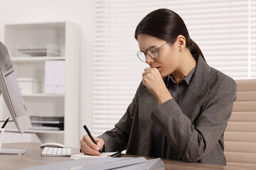 Woman coughing while taking notes at table in office, space for text. Cold symptoms