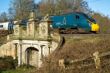 COLWICH, STAFFORDSHIRE, ENGLAND. JANUARY 2024. Avanti train travelling over a railway bridge on the West Coast mainline railway.