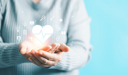 Woman hand holding heart shape for technology healthcare medical icon. access to welfare health and copy space, medical health care with medical network connection, Health insurance health concept.