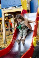 a playful and contented child plays on the old municipal playground