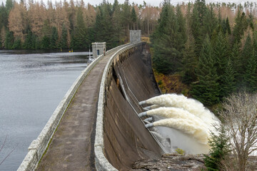 Laggan dam with powerful water flowing through pipes