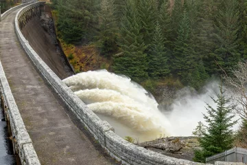 Foto op Canvas Laggan dam with powerful water flowing through pipes © Sarah