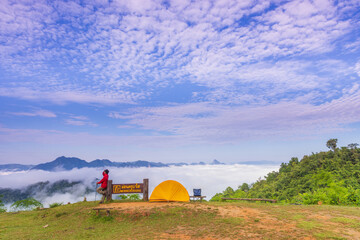 Man tourist with his orange tent in Mae Moei Nationnal Park border of Thailand and Myan Mar, Tak...