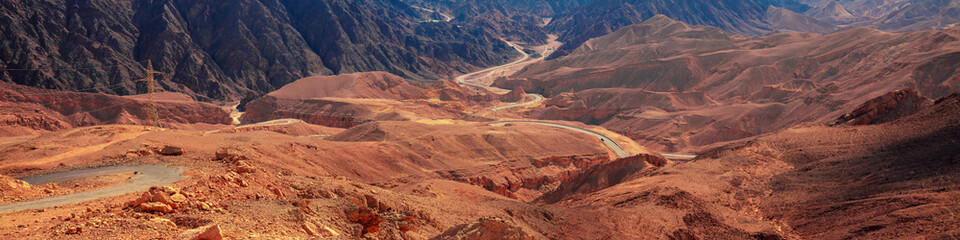 Beautiful mountain landscape with winding mountain road. Mountains background. Horizontal banner