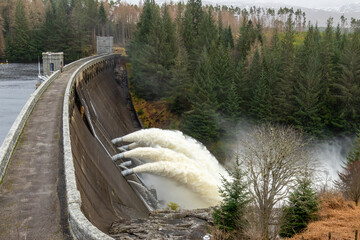 Laggan dam with powerful water flowing through pipes