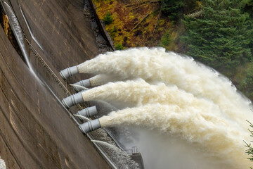 Laggan dam with powerful water flowing through pipes