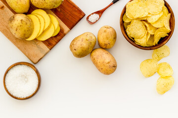 Cooking homemade potato chips - oven backed raw potatoes with salt