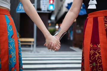 lgbtq couples openly walk hand in hand down street to show lgbtq rights and freedoms of love for...