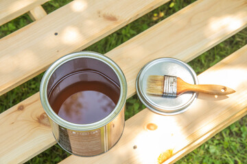 Image of paint brush on the opened can with primer on the wooden table. painting and renovation...