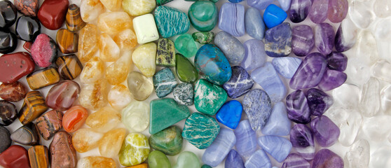 Chakra Crystal Healing wide Background template - Rows of tumbled polished healing crystal laid out...