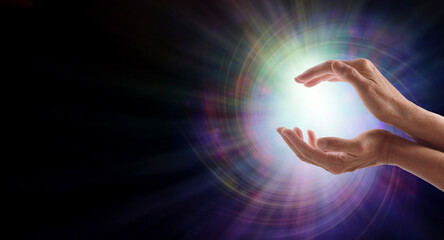Sending Vortex Healing Energy Concept- female cupped hands with a beautiful white star burst orb ...