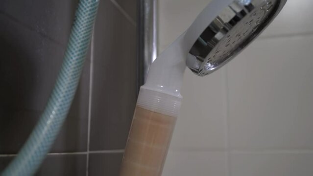 Close-up view of the shower head filtration system in the bathroom. 