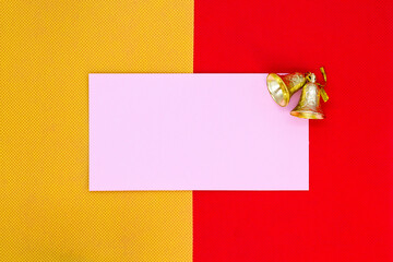 Red and yellow background with a white sheet of paper and a bell