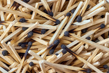 Burnt wooden matches are scattered in a chaotic manner. Backdrop for mockup design