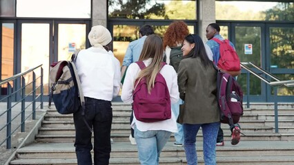 University student girl friends arriving to University, walking staircase to enter school building 