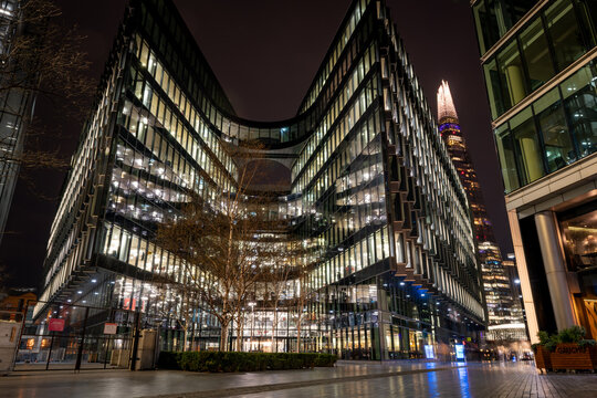 London. UK-01.27.2024. A night time  exterior view of 7 More London Riverside. A modern office block which include the offices of PricewaterhouseCoopers LLP or PwC. Business consultant firm.