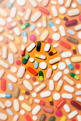 Colorful pills on orange background, medical background
