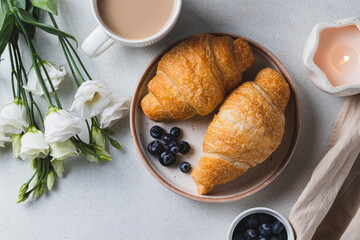 Croissants on a plate with blueberries