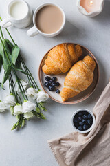 Croissants on a plate with blueberries