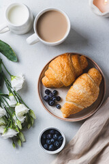 Croissants on a plate with blueberries