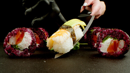 Close-up of bright and fresh sushi rolls on a dark studio background. The concept of healthy food, seafood and fresh fish. Sushi menu, Japanese and Asian cuisine.