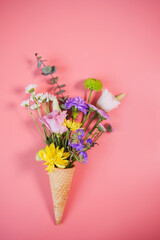Waffle cone with bouquet of beautiful spring flowers