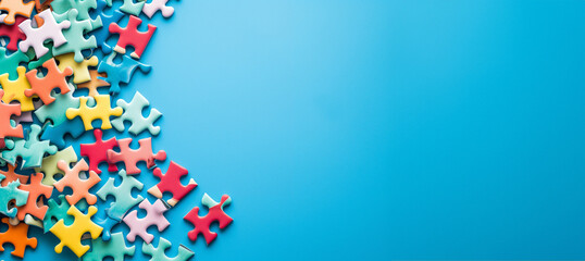 colorful puzzle pieces on a vibrant blue background with plenty of copy space with copy space. Colorful jigsaw puzzle pieces on a blue background. Problem solving concepts. Texture photo with copy spa
