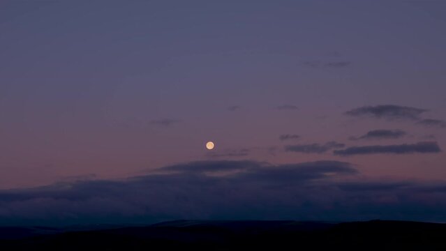 4k timelapse night to day landscape with moonset and moving clouds. 