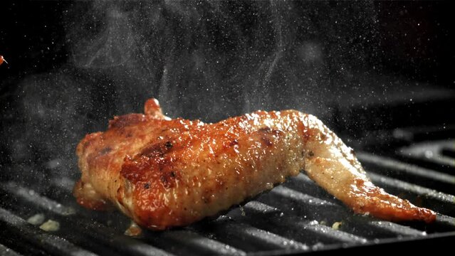Chicken wing are fried in a pan. Filmed on a high-speed camera at 1000 fps. High quality FullHD footage