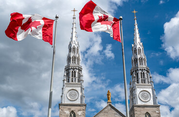 Canadian flags in the forefront of the Notre-Dame Cathedral Basilica in Ottawa. Canada.