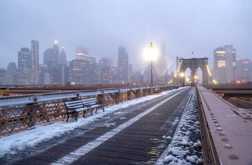 Brooklyn Bridge is covered under a blanket of snow. New York, USA