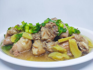 Steamed chicken meat with ginger served on plate isolated on white background