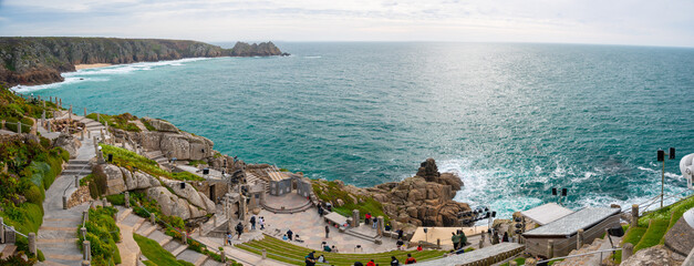 The Minack Theatre, Cornwall's famous open-air theater, carved into the granite cliff and set in glorious gardens overlooking the spectacular panorama of Porthcurno Bay.