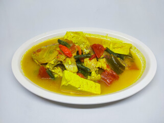 Tilapia fish in yellow sauce or Turmeric Tilapia Fish Soup, specifically for freshwater fish from Indonesia. Healthy food with local herbs and spices