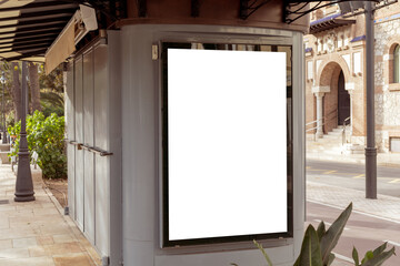 Empty outdoor advertisement space on a kiosk, nestled on a city street with tropical foliage, ideal...