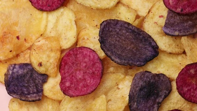 Tricolor sweet potato chips, rotation in circle. Fried chips from the barracks (fast food), Turning. selective focus. vegetable chips	