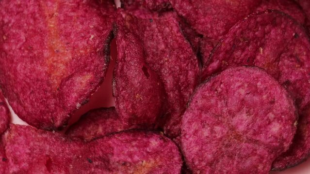 pink sweet potato chips, rotation in circle. Fried pink chips from the barracks (fast food), Turning. selective focus. vegetable chips	