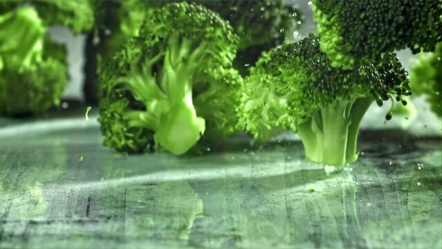 Dropping broccoli with splashing water. Filmed on a high-speed camera at 1000 fps. High quality FullHD footage