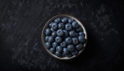 top view of blueberry in bowl with empty space, on a black background