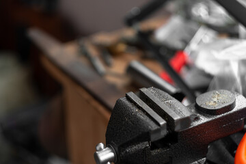 Naklejka premium Small locksmith vices, clamps, for small household works. Workshop. Copy space. Tools. Selective focus