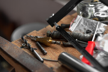 Top view of drills on the table, different types, for metal, and for different hole diameters. Tool. Workshop concept. another equipment on wood table. repairing home