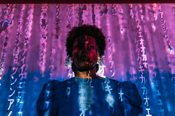 Digital code falling on woman in front of wall