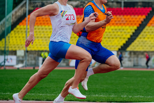 blind male athlete runner with guide running race, summer para athletics championships