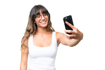 Young caucasian woman over isolated background making a selfie with mobile phone