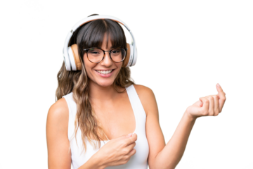 Young caucasian woman over isolated background listening music and doing guitar gesture