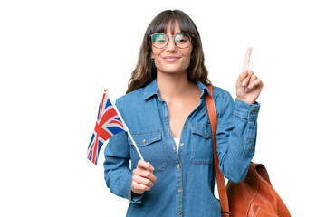 Young caucasian woman holding an United Kingdom flag over isolated background pointing up a great...
