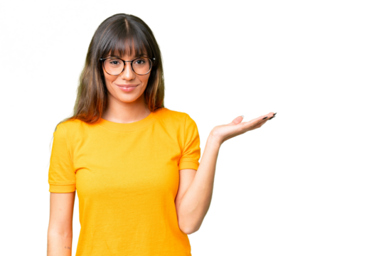 Young caucasian woman over isolated chroma key background holding copyspace imaginary on the palm to insert an ad