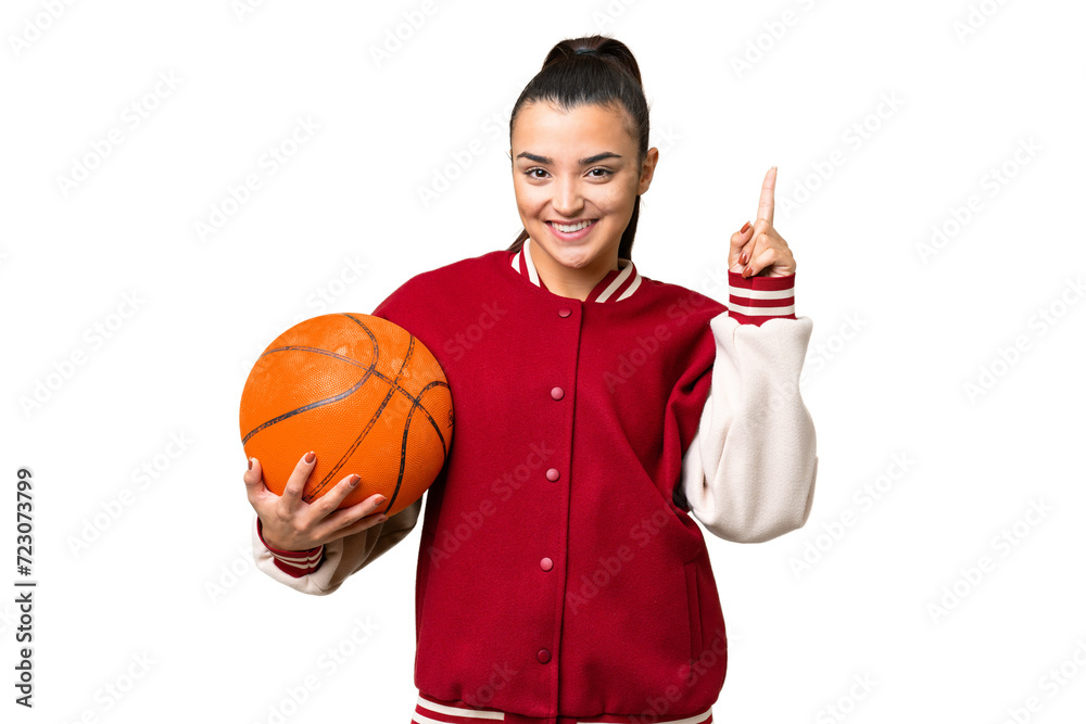 Wall mural Young Woman playing basketball over isolated chroma key background pointing up a great idea