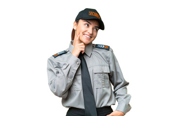 Young safeguard woman over isolated chroma key background thinking an idea while looking up